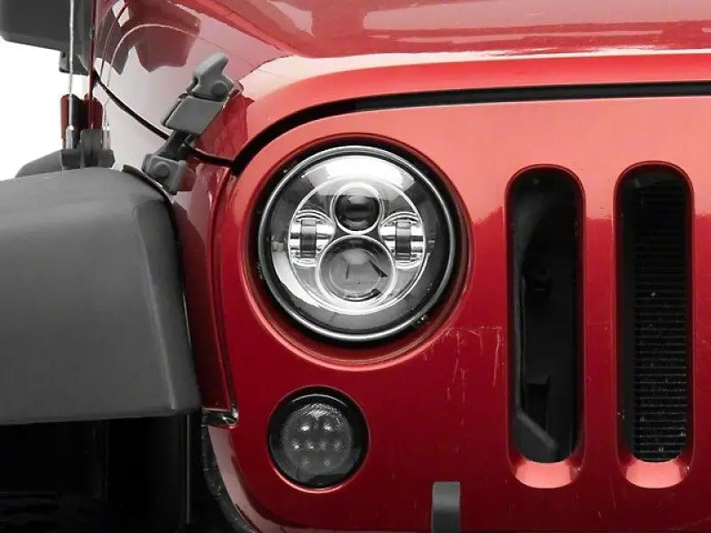Red Jeep headlight featuring Raxiom led daymaker headlights for Jeep Wrangler TJ/JK