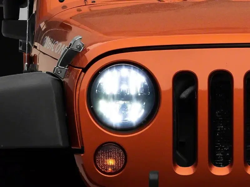 Orange Jeep Wrangler front with Raxiom axial series led headlights in black housing