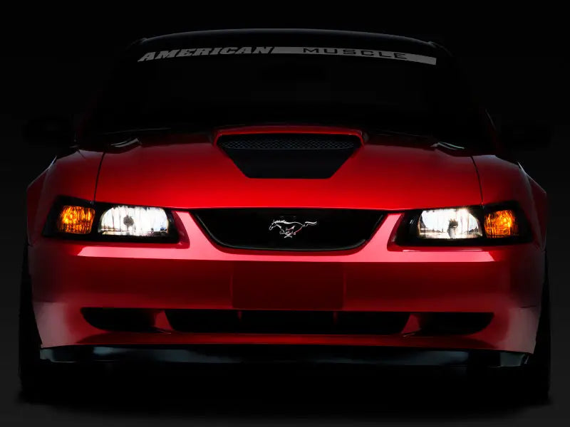 Red Ford Mustang front view with Raxiom Axial Series OE Style Headlights smoked lens