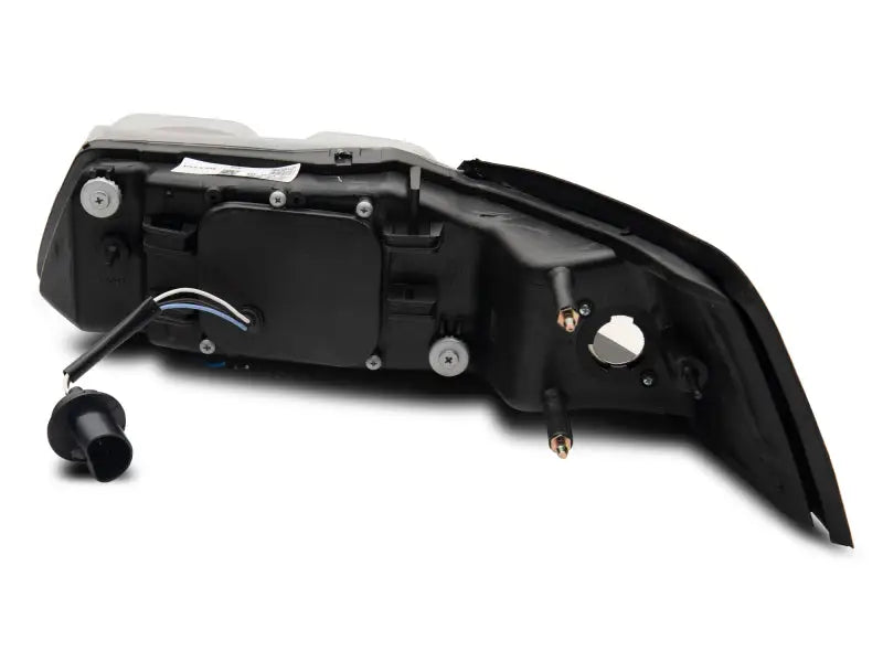 Rear car light assembly showing Raxiom LED halo projector headlights for Ford Mustang