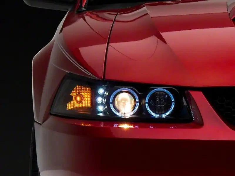 Red car headlight with LED halo projector rings on black housing for Ford Mustang