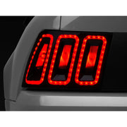 Raxiom 100807 Raxiom 99-04 Ford Mustang Excluding 99-01 Cobra Icon LED Tail Lights- Black Housing (Smoked Lens)