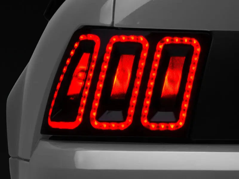 Raxiom 99-04 Ford Mustang Excluding 99-01 Cobra Icon LED Tail Lights- Black Housing (Smoked Lens) - Truck & Automotive