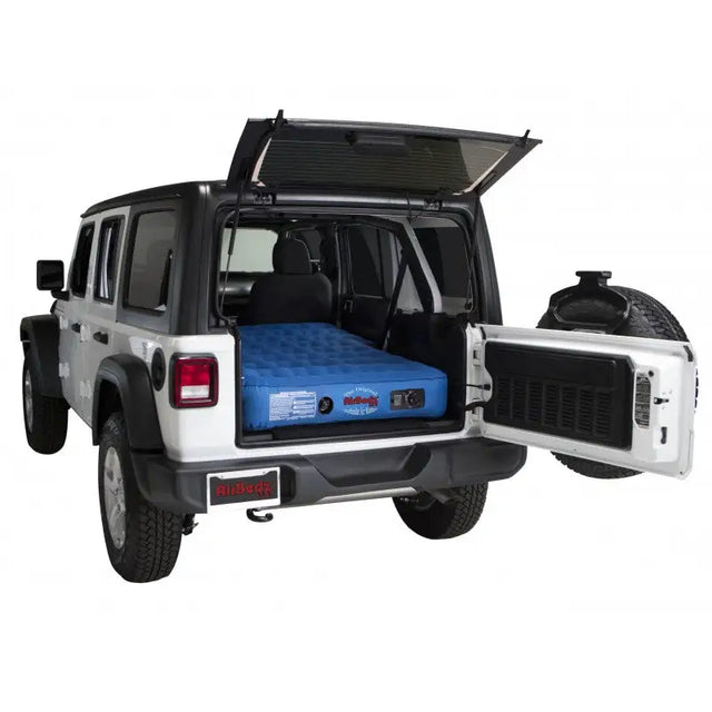 White Jeep Wrangler with an air mattress.