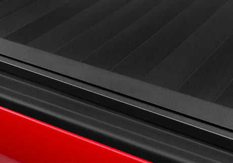 Black truck bed cover for Tacoma 5ft Double Cab RetraxPRO XR in action