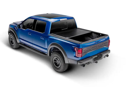 Blue Ford Raptor pickup with bed cover on Toyota Tundra CrewMax 5.5ft Tundra CrewMax