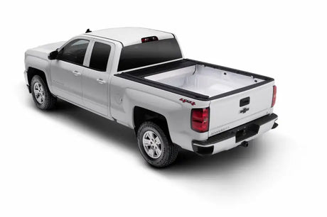 White pickup truck with bed liner on Toyota Tundra CrewMax Retrax IX topper