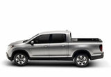 Silver four-door pickup truck with Ridgeline RetraxPRO MX and sealed ball-bearing rollers
