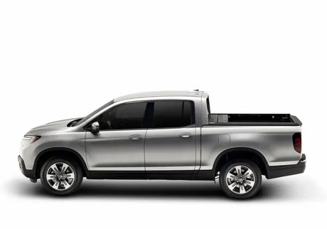 Silver four-door pickup truck with Ridgeline RetraxPRO MX and sealed ball-bearing rollers