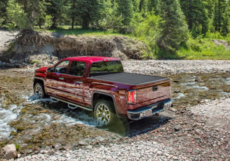 Red pickup truck with Ridgeline RetraxPRO MX truck bed cover and sealed ball-bearing rollers