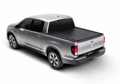Silver Ridgeline RetraxPRO MX with truck bed tonneau cover and sealed ball-bearing rollers