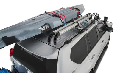 White SUV with roof rack and kayak using Rhino-Rack Nautic Kayak Lifter for easy transport