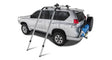 Silver SUV with roof rack and spare tire using Rhinorack Nautic Kayak Lifter for kayak hauling