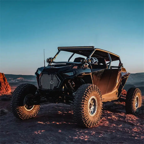 Black off-road vehicle with Rigid 430613 Revolve 30 Inch Bar Wht Backlight in action