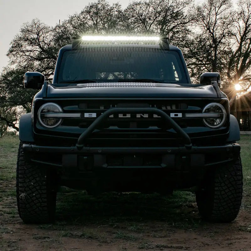 Black Ford Bronco with roof rack and Rigid Industries light bar for off-road adventures