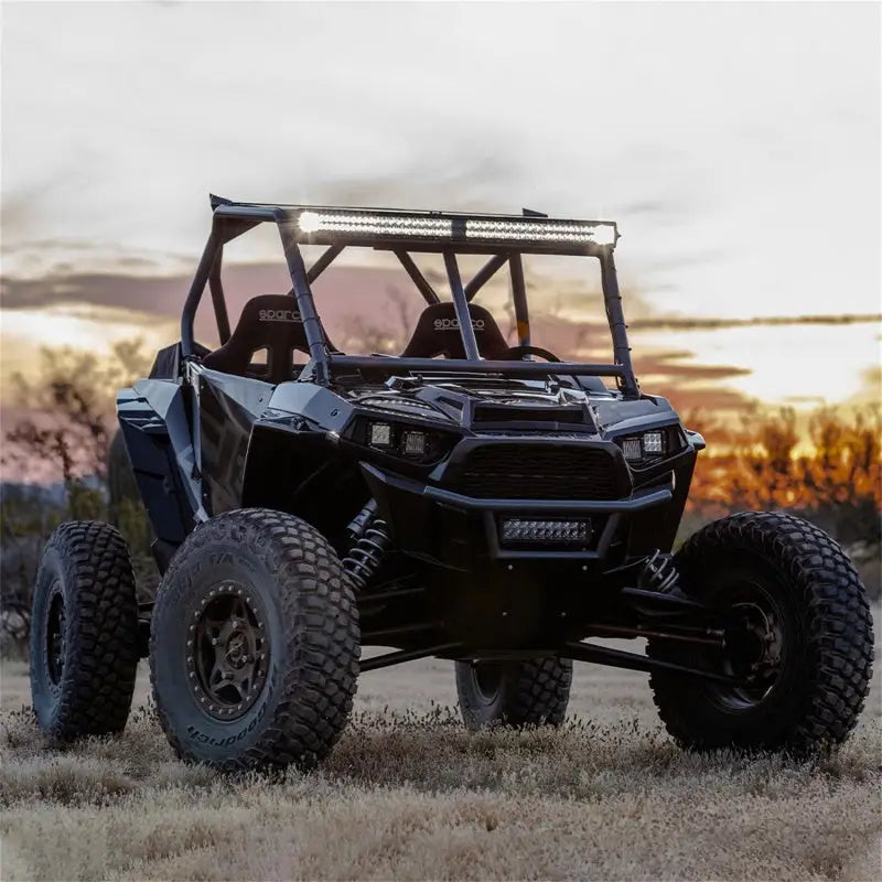 Black off-road vehicle with Rigid Industries 20in Adapt E-Series Light Bar shining bright