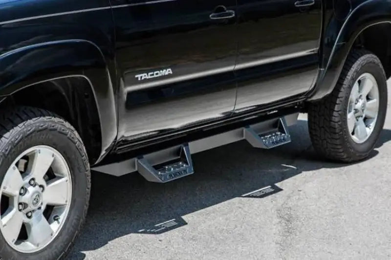 Black truck with side steps featuring RTS75TY ICI Stainles RT Steps for easy access