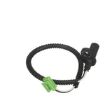 Black ABS sensor with green connector.