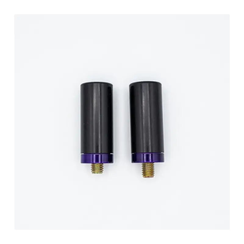 Two black cylindrical fabworx bag guard parts with purple bases and gold screws
