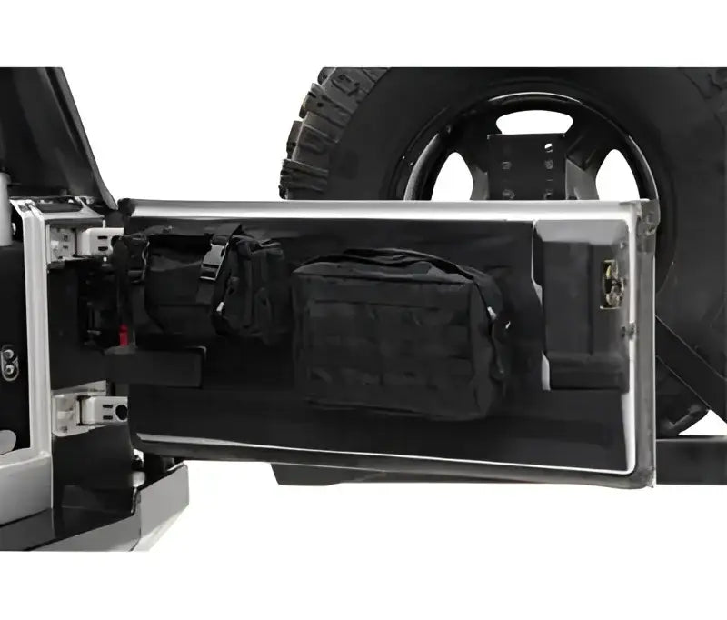 Smittybilt Gear Tail Gate Cover Blk - 5662201 installed on a vehicle, showcasing its durable black material and organized gear storage.