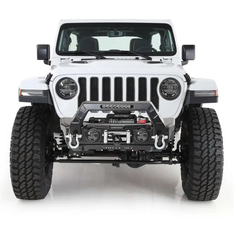 Smittybilt Gear Tail Gate Cover in sleek black, featured on a rugged white off-road vehicle. Enhances protection and style, easy installation, fits various models.