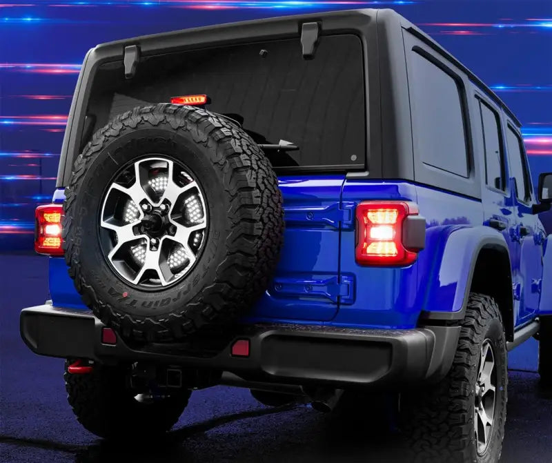 Spare Tire Brake Light with Smoke Lens and Red/White LED Bulbs on a Blue Jeep, Featuring Sequential Turn Signals, Running, Brake, and Reverse Functions, 4 Pin Trailer Plug or Hard Wire Installation.