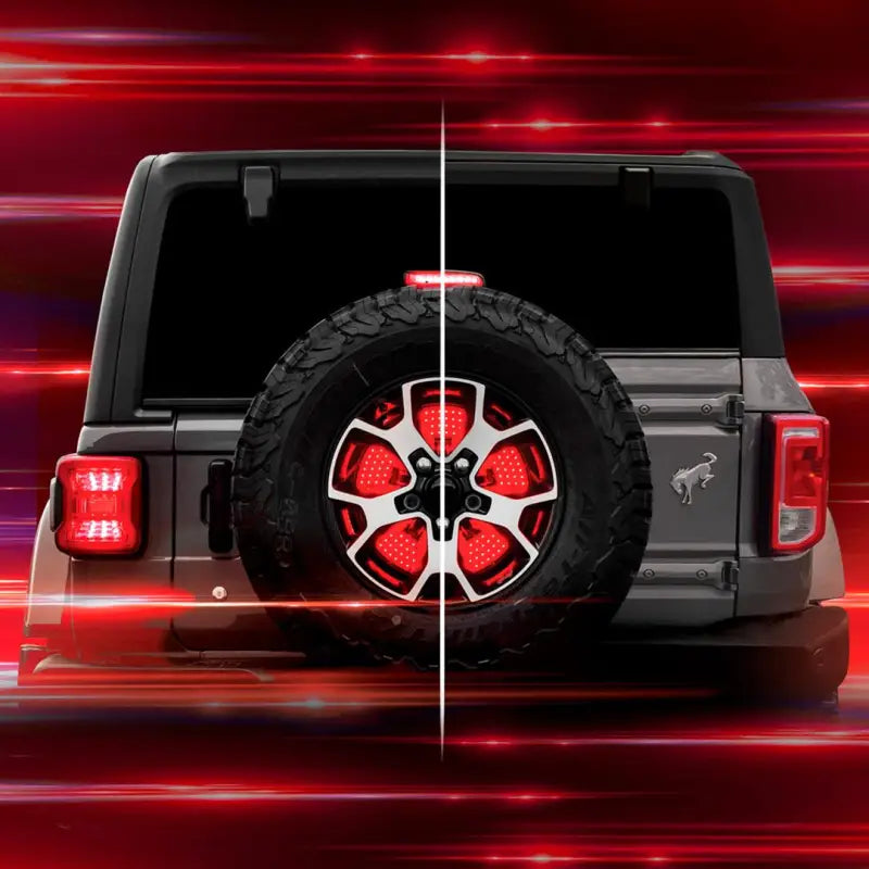Spare tire with illuminated smoke lens, red and white LED brake light featuring running, brake, reverse, and sequential turn functions, mounted on SUV rear using hub with XKGLOW LEDs.