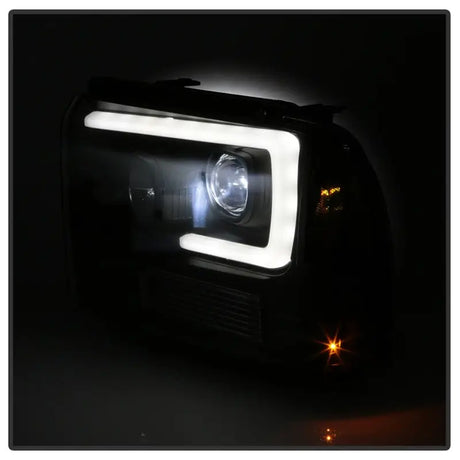 Black aftermarket super duty projector LED headlights with white DRL strip and bright projector beam