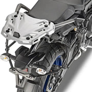 Rear view of motorcycle with matte black luggage mounting hardware and silver rack