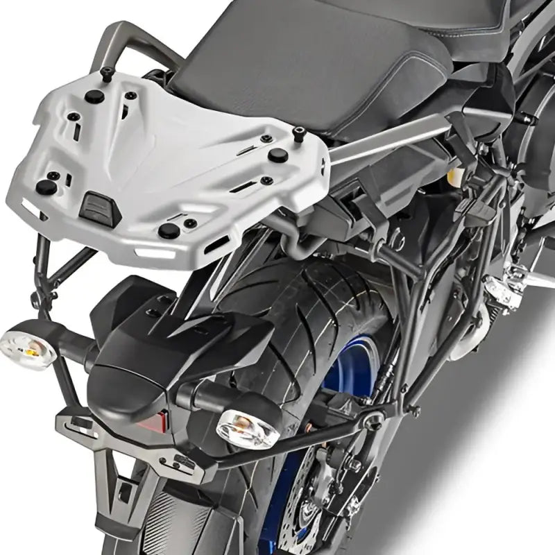 Rear view of motorcycle with matte black luggage mounting hardware and silver rack