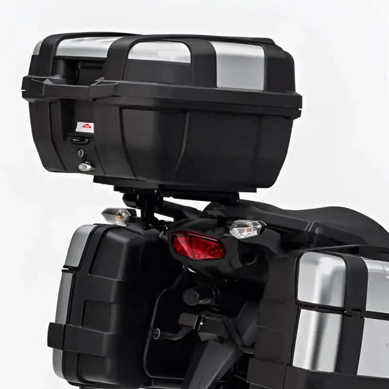Black motorcycle top case and side cases with silver accents for matte black hard luggage mounting