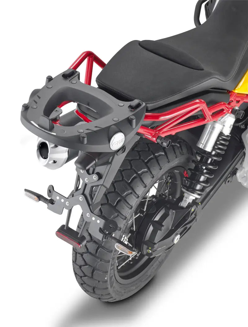 Rear view of motorcycle with matte black luggage mounting hardware and knobby tires