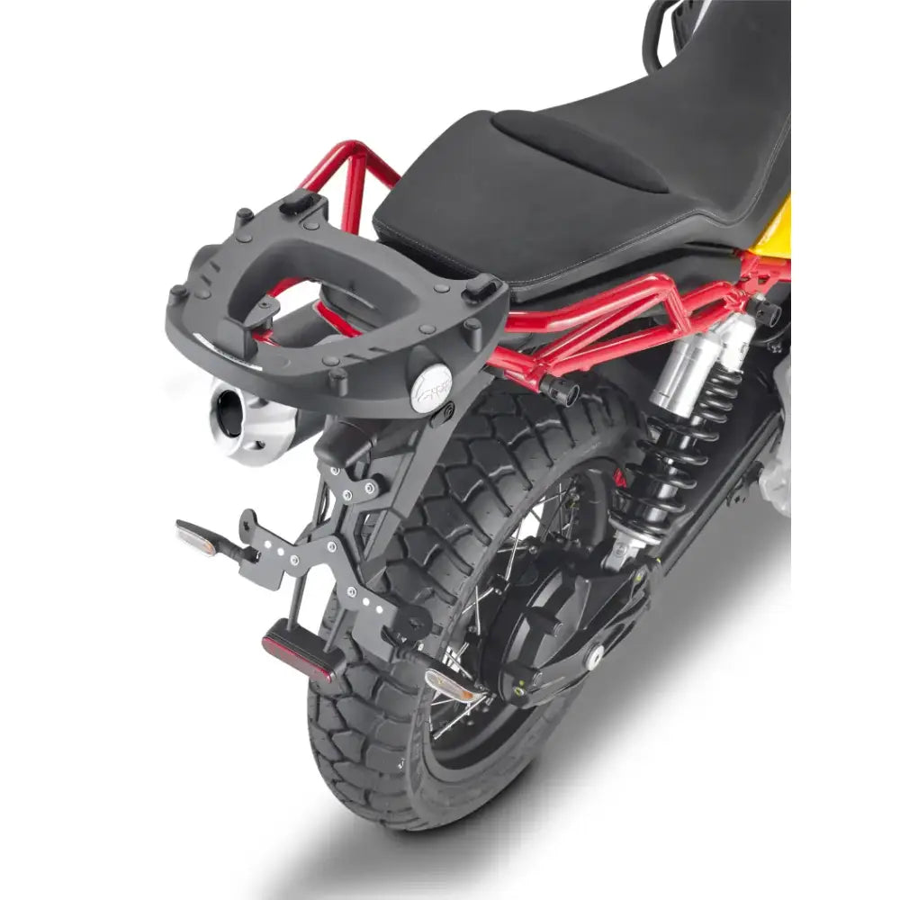 Rear view of motorcycle with matte black luggage mounting hardware and knobby tires