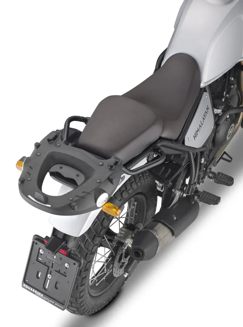 Rear view of white motorcycle with matte black luggage mounting hardware and grab handles