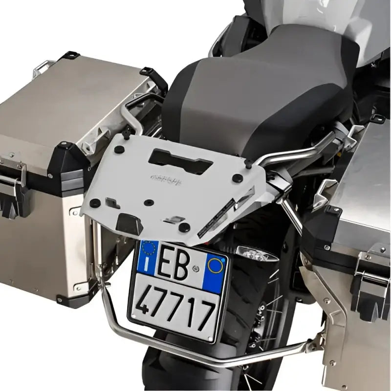 Rear view of motorcycle with matte black hard luggage mounting hardware and side cases