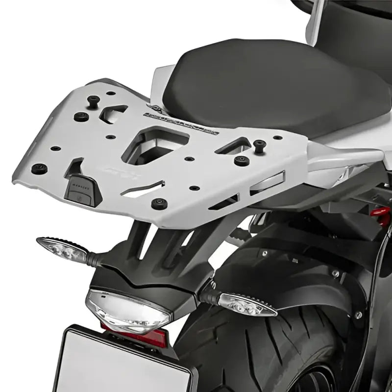 Silver motorcycle luggage rack for hard luggage mounting above rear wheel, OEM hardware