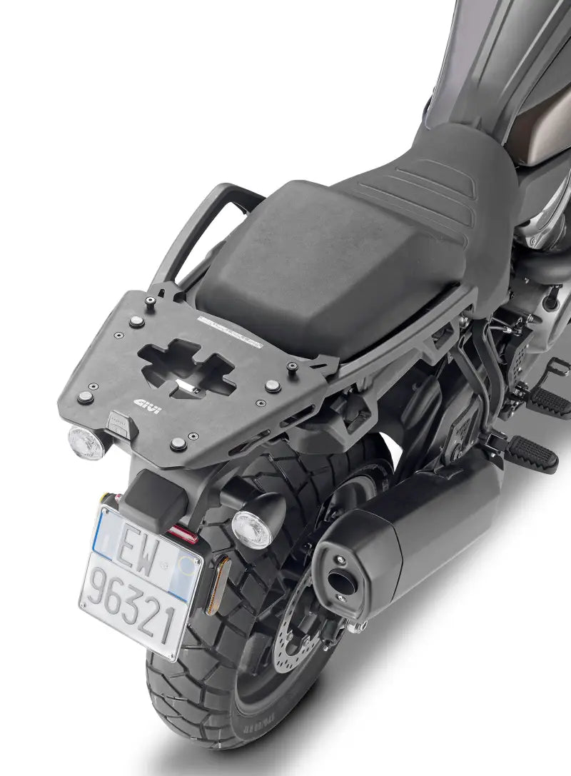 Motorcycle with matte black hard luggage mounting hardware and rear exhaust pipe