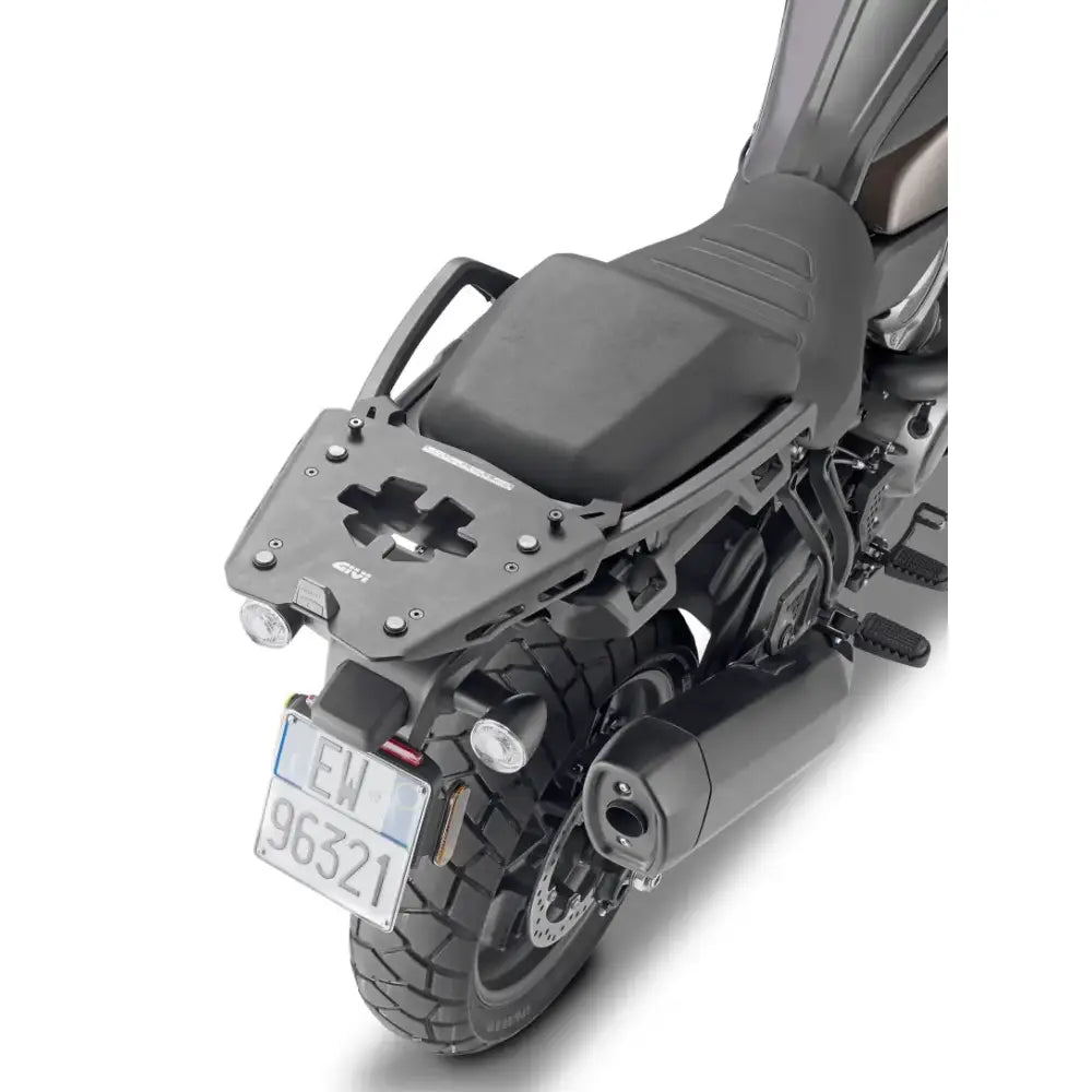 Motorcycle with matte black hard luggage mounting hardware and rear exhaust pipe