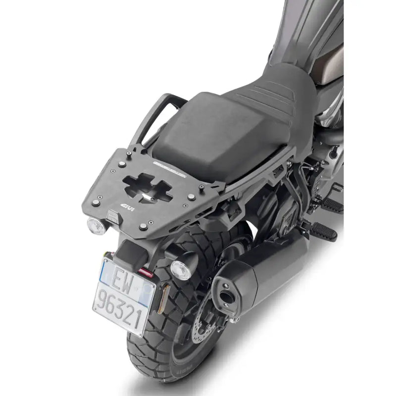 Motorcycle with matte black hard luggage mounting hardware and rear exhaust pipe