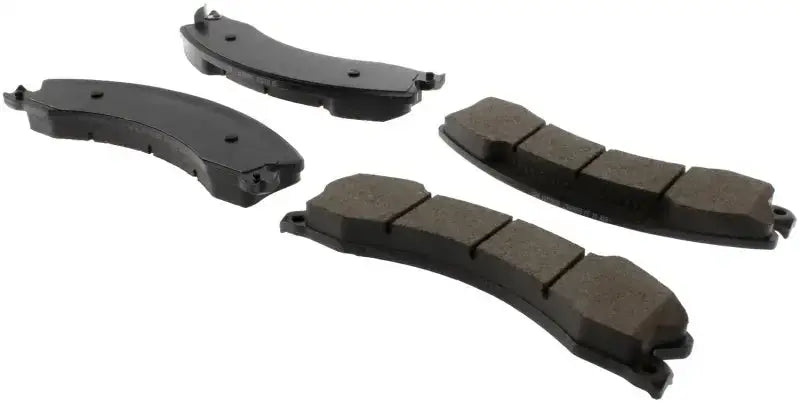 Four black curved StopTech Street Brake Pads with segmented friction for street brake pads