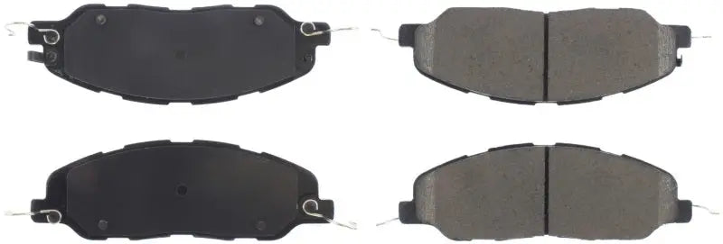 Four StopTech Street Select Brake Pads with backing plates and friction material for front use