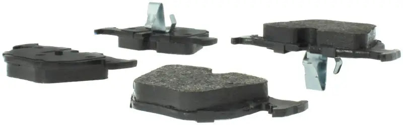 Four StopTech Street Select brake pads with metal clips for front brake upgrade