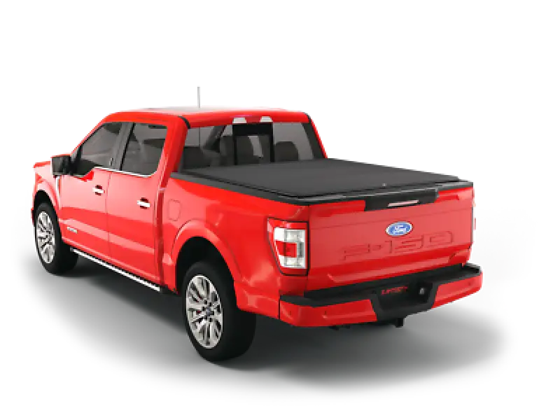 Red Ford F-150 pickup truck with tonneau cover.