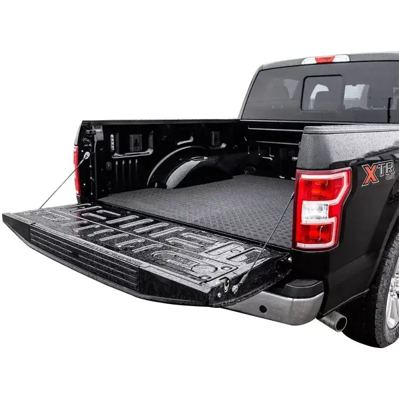Open black pickup truck bed featuring the TG3-043-07 Legend Fleet Pickup Truck Bed Automat Bar Rubber, providing a non-slip surface for secure cargo transport, ideal for RV, Automotive, Powersports, off-road, marine, exterior, and interior truck accessories, Truck Bed Accessories, AVADA - Best Sellers, Must Haves