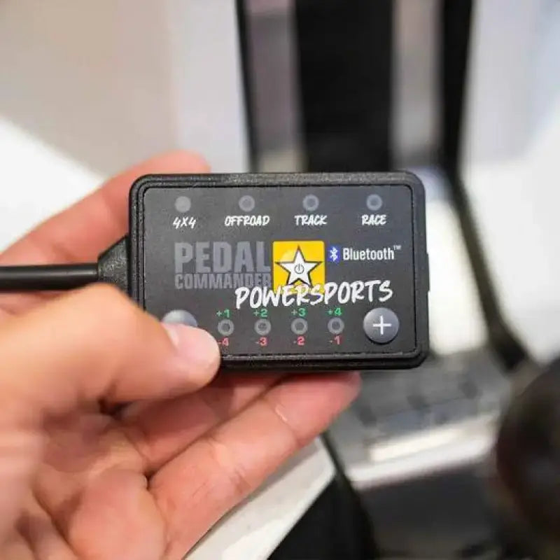 Black Pedal Commander Powersports control module for throttle sensitivity booster and tuning