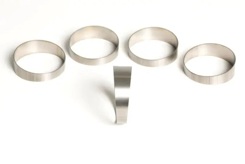 Five titanium pie cuts rings from Ticon Industries for custom pipe fitting projects