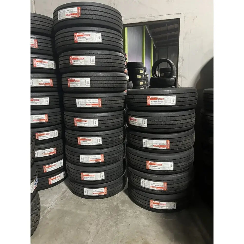 TL00082600 Maxxis tire stack with black rubber and red white labels