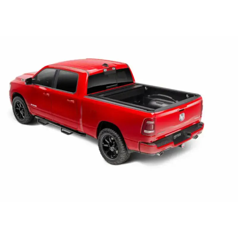 Red pickup truck with black matte Tonneau Cover Manual Retractable and Trax Rail System