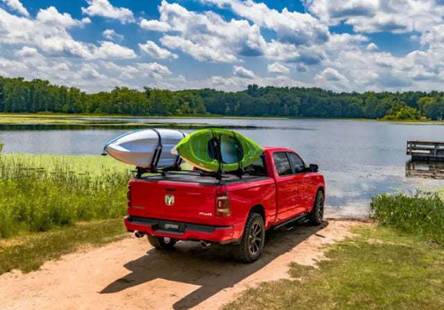 Red pickup truck with kayaks showcasing Tonneau Cover Manual Retractable with Trax Rail System