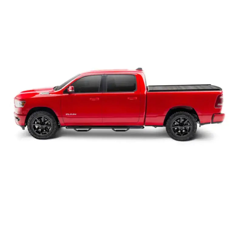 Red four-door pickup truck with black matte Tonneau Cover Manual Retractable and Trax Rail system